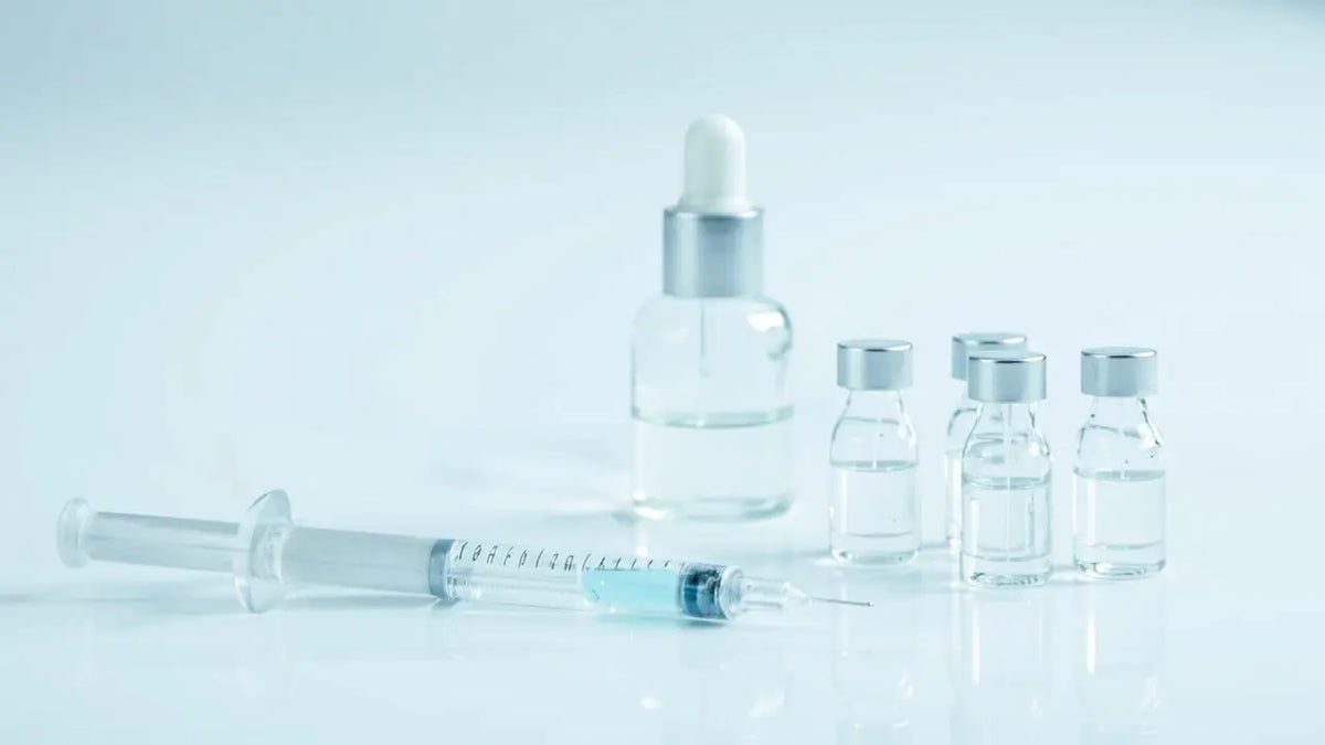 Clear glass GHK-Cu peptide dropper bottle with silver cap and 4 vials