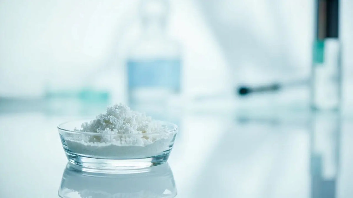 Clear glass petri dish with fine white peptide crystals for India buyers